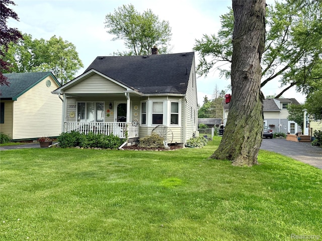 35717 Columbia Ave, Westland, MI 48186 - view of front facade with a porch, a chimney, a front yard, and roof with shingles
