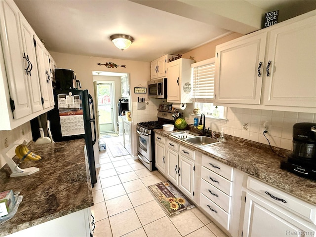 35717 Columbia Ave, Westland, MI 48186 - kitchen featuring appliances with stainless steel finishes, tasteful backsplash, washer and clothes dryer, and light tile patterned flooring