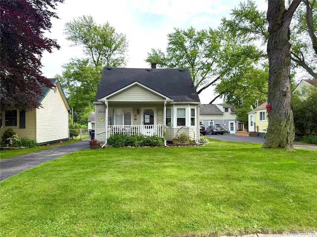 35717 Columbia Ave, Westland, MI 48186 - bungalow featuring a porch, a front lawn, roof with shingles, and driveway