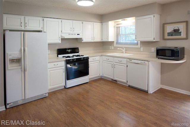 5280 Weston Ct, Commerce Twp, MI 48382 - kitchen featuring white appliances, under cabinet range hood, light countertops, white cabinetry, and wood finished floors