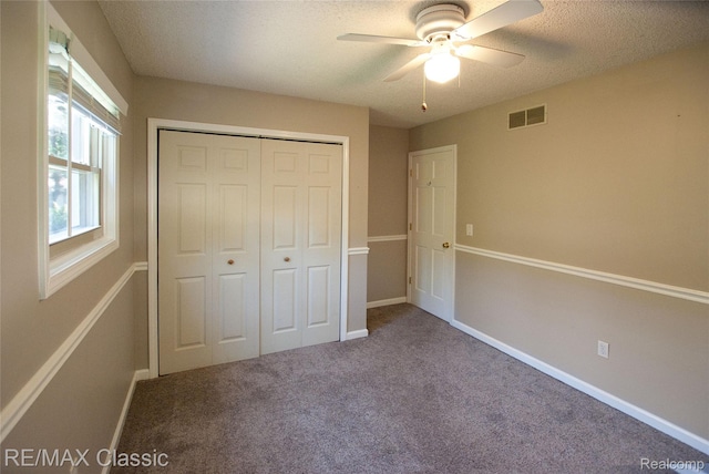 5280 Weston Ct, Commerce Twp, MI 48382 - unfurnished bedroom with a closet, carpet, a textured ceiling, and ceiling fan