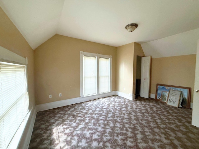 512 E Main St, Owosso, MI 48867 - unfurnished living room with vaulted ceiling and carpet floors