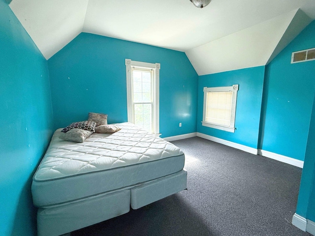512 E Main St, Owosso, MI 48867 - bedroom with lofted ceiling and carpet flooring