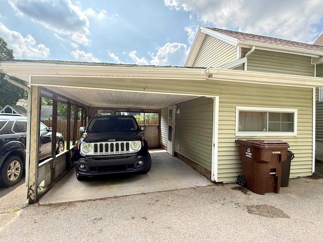 512 E Main St, Owosso, MI 48867 - view of car parking featuring a carport and driveway