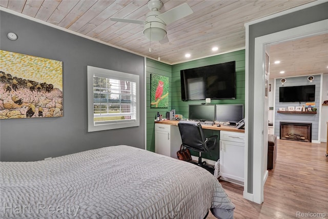 1191 W Frenchline Rd, Sandusky, MI 48471 - bedroom with wood ceiling, light wood finished floors, a fireplace, recessed lighting, and built in desk