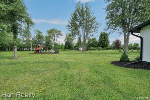 1191 W Frenchline Rd, Sandusky, MI 48471 - view of grassy yard with a playground