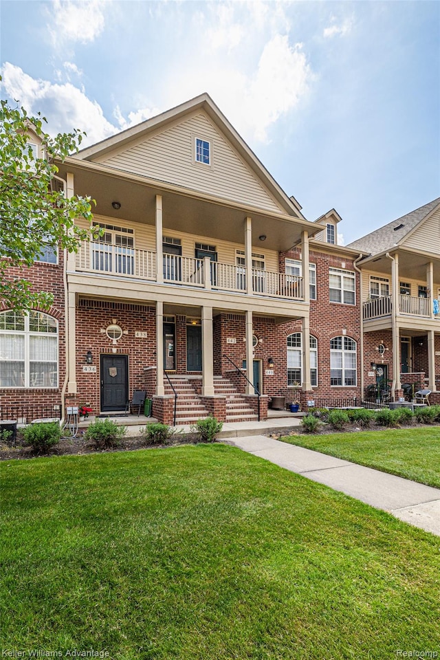 438 Old Pine Way, Walled Lake, MI 48390 - view of front facade featuring a balcony, brick siding, covered porch, and a front yard