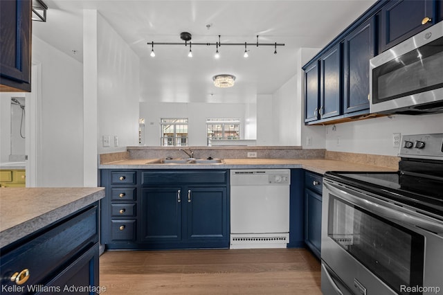 438 Old Pine Way, Walled Lake, MI 48390 - kitchen with appliances with stainless steel finishes, blue cabinetry, light wood-style flooring, and light countertops