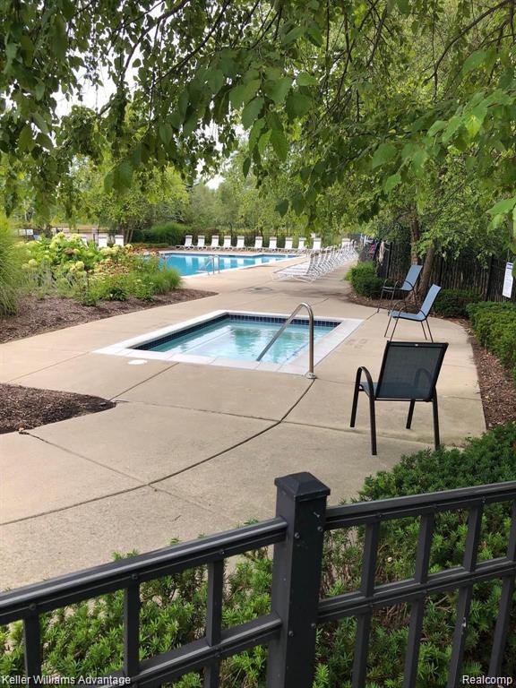 438 Old Pine Way, Walled Lake, MI 48390 - community pool featuring a hot tub and a patio area