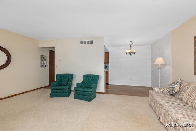 666 Waterview Ct SW, Grandville, MI 49418 - carpeted living area featuring a chandelier and wood walls