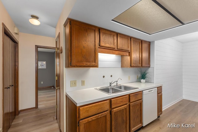 666 Waterview Ct SW, Grandville, MI 49418 - kitchen with white dishwasher, light wood finished floors, light countertops, and brown cabinetry