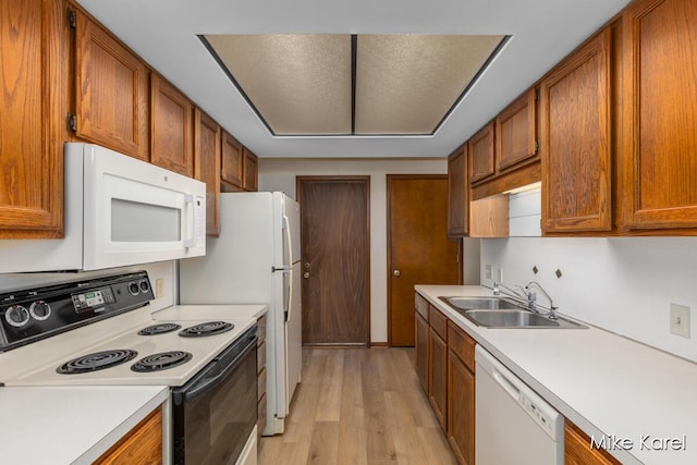 666 Waterview Ct SW, Grandville, MI 49418 - kitchen with white appliances, brown cabinetry, light wood finished floors, and light countertops