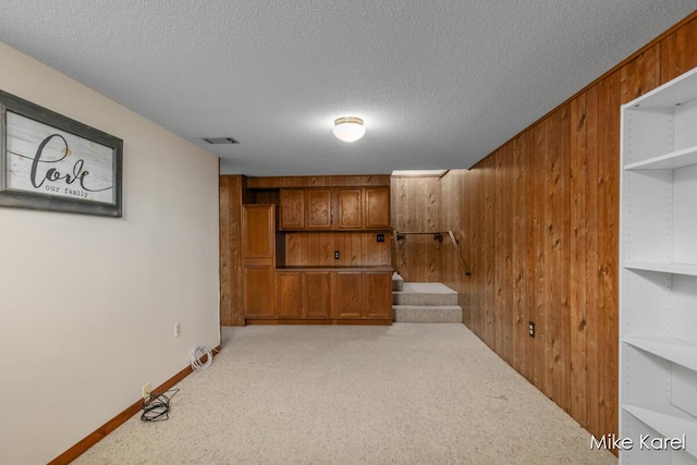 666 Waterview Ct SW, Grandville, MI 49418 - finished basement with wood walls, carpet floors, a textured ceiling, and stairway