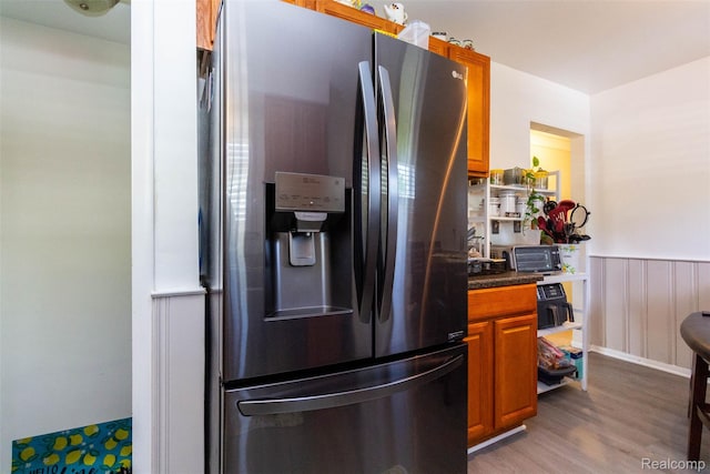 24645 Greenbrier Ave, Eastpointe, MI 48021 - kitchen featuring stainless steel fridge, brown cabinets, wood finished floors, dark countertops, and wainscoting