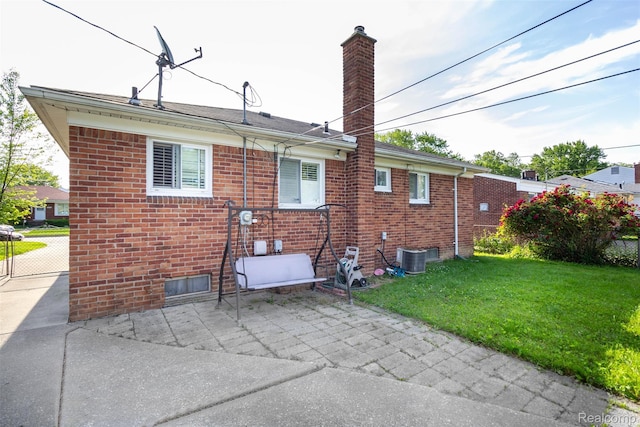24645 Greenbrier Ave, Eastpointe, MI 48021 - back of property featuring brick siding, a chimney, a patio area, and a lawn
