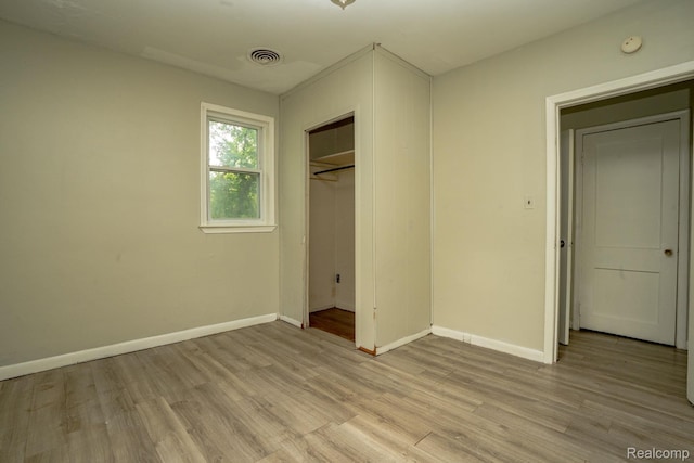 21890 Sharkey St, Clinton Township, MI 48035 - unfurnished bedroom with light wood-style floors and a closet