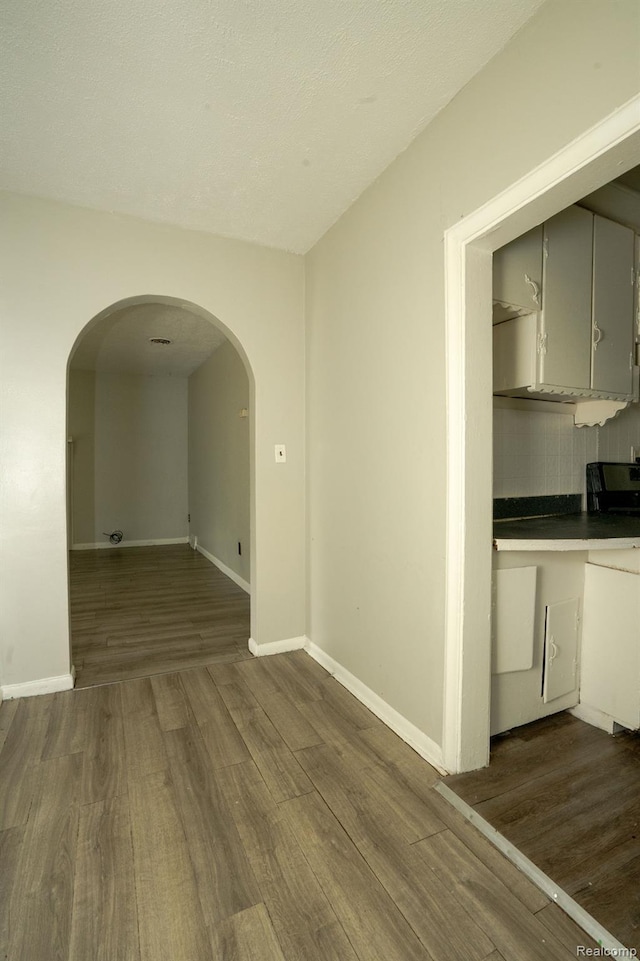21890 Sharkey St, Clinton Township, MI 48035 - empty room featuring arched walkways and wood finished floors