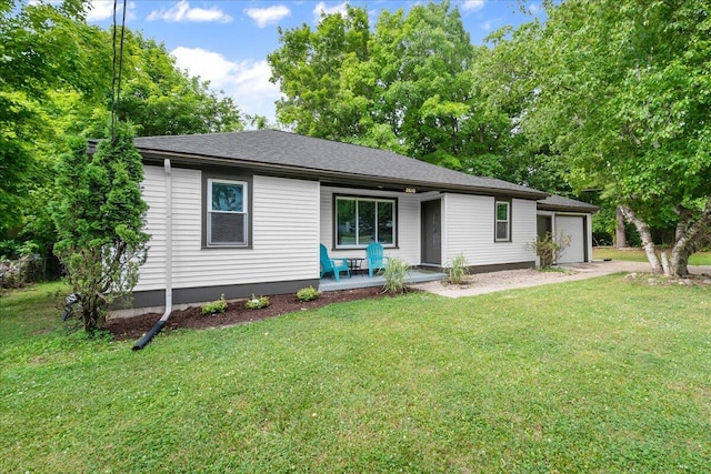 2610 32nd St SE, Kentwood, MI 49512 - ranch-style house with a porch, an attached garage, and a front yard