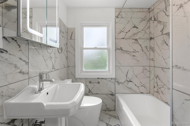 16629 Hubbell St, Garden City, MI 48235 - bathroom featuring a bathtub, tile walls, and marble finish floors
