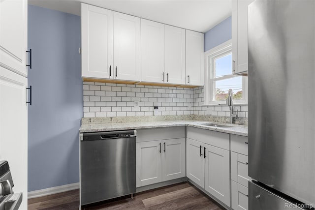 16629 Hubbell St, Garden City, MI 48235 - kitchen with appliances with stainless steel finishes, dark wood-type flooring, backsplash, white cabinets, and light stone countertops