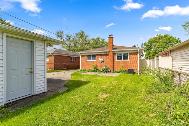 7420 Colonial St, Dearborn Heights, MI 48127 - back of house featuring a chimney and brick siding