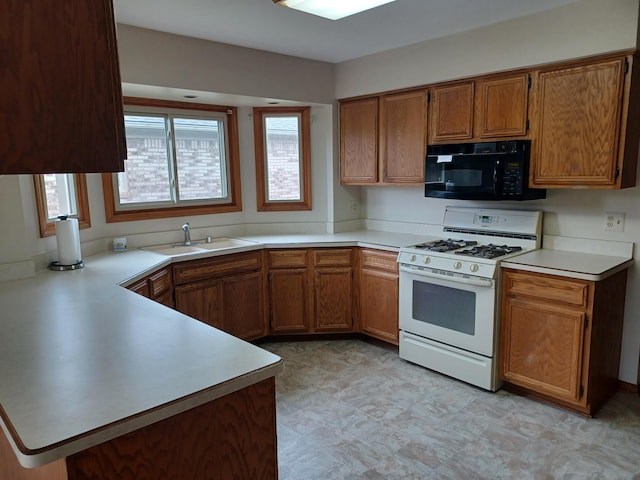 46817 Barbara Dr, Macomb, MI 48044 - kitchen featuring black microwave, white gas range oven, healthy amount of natural light, and a peninsula