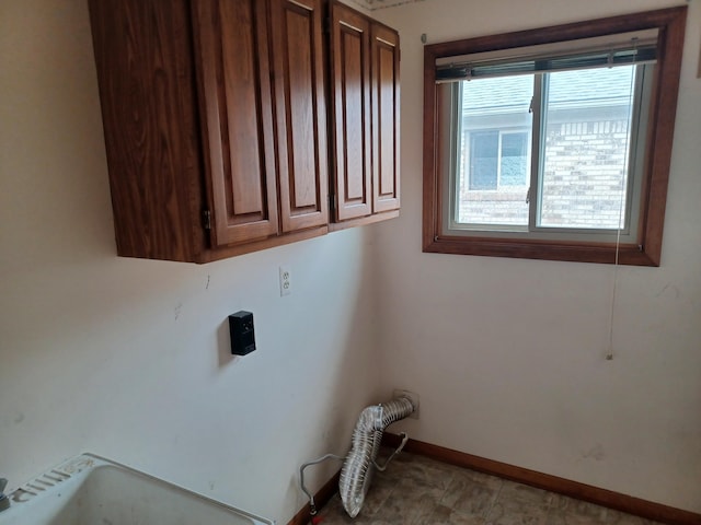 46817 Barbara Dr, Macomb, MI 48044 - laundry area featuring baseboards and cabinet space