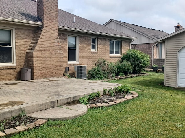 46817 Barbara Dr, Macomb, MI 48044 - rear view of property featuring brick siding, a patio area, and a yard