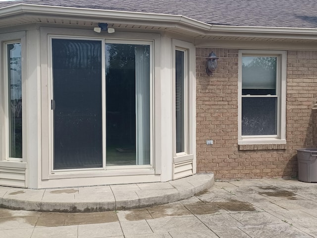 46817 Barbara Dr, Macomb, MI 48044 - view of exterior entry with a shingled roof and brick siding