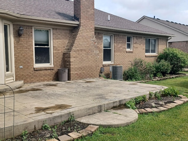 46817 Barbara Dr, Macomb, MI 48044 - back of house with roof with shingles, a chimney, a patio area, and brick siding
