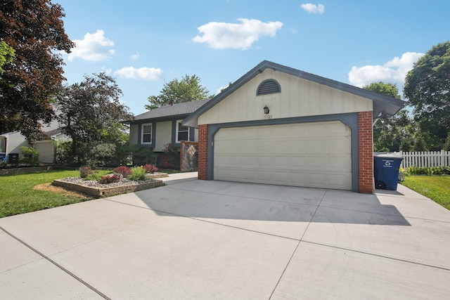 3320 Bluett Dr, Ann Arbor, MI 48105 - ranch-style house featuring driveway, an attached garage, and brick siding