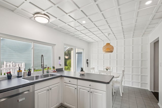 3320 Bluett Dr, Ann Arbor, MI 48105 - kitchen featuring stainless steel dishwasher, light tile patterned flooring, a peninsula, white cabinets, and recessed lighting