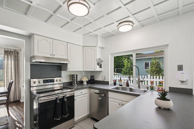 3320 Bluett Dr, Ann Arbor, MI 48105 - kitchen with stainless steel appliances, under cabinet range hood, white cabinets, coffered ceiling, and dark countertops