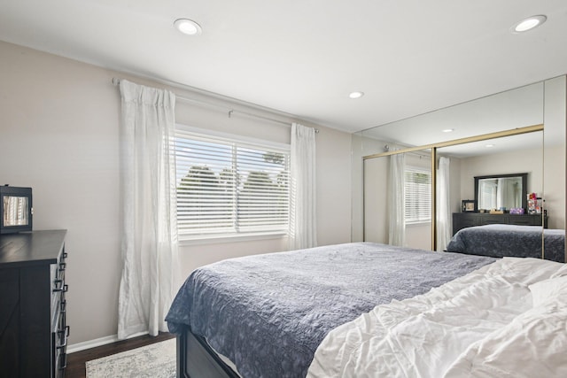 3320 Bluett Dr, Ann Arbor, MI 48105 - bedroom featuring multiple windows, dark wood-type flooring, recessed lighting, and a closet