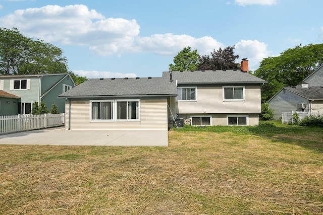 3320 Bluett Dr, Ann Arbor, MI 48105 - back of house with a patio area, a chimney, and roof with shingles