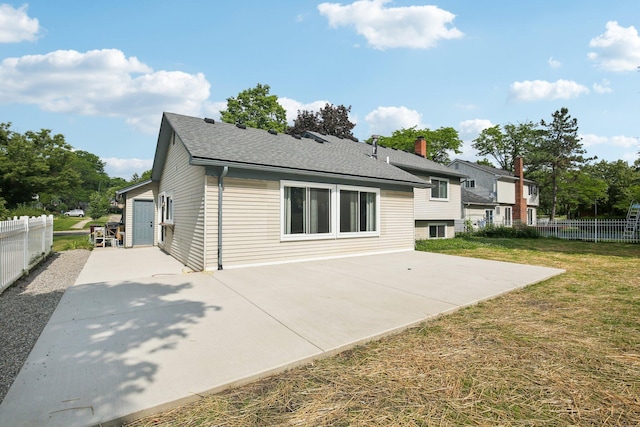 3320 Bluett Dr, Ann Arbor, MI 48105 - rear view of property with a patio and roof with shingles