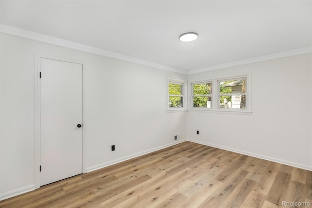 16952 Mount Vernon St, Wixom, MI 48075 - spare room with light wood-style floors and ornamental molding