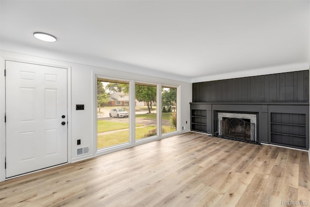 16952 Mount Vernon St, Wixom, MI 48075 - unfurnished living room with light wood-style floors and a fireplace