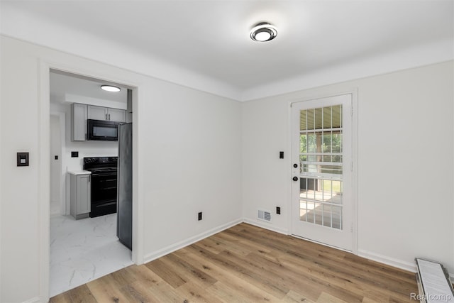 16952 Mount Vernon St, Wixom, MI 48075 - unfurnished room with baseboards and light wood-style floors