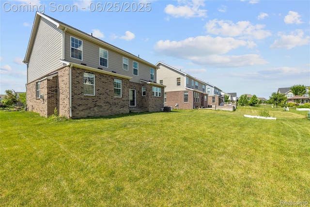 51008 Woodford Dr, Canton, MI 48188 - back of house featuring brick siding, a yard, and a residential view