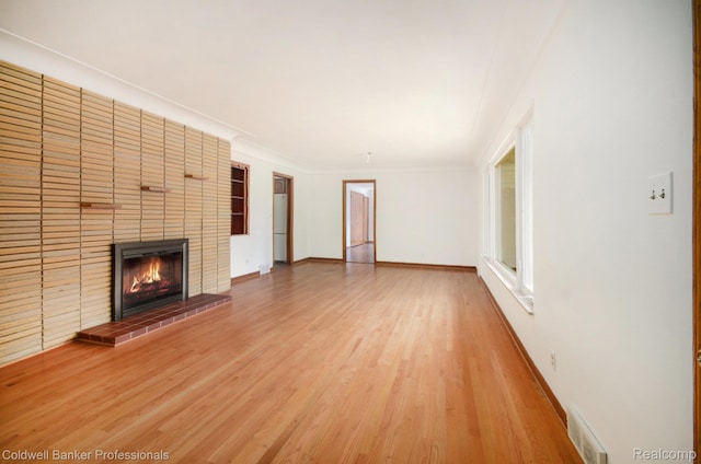 2740 Judah Rd, Lake Orion, MI 48359 - unfurnished living room with a fireplace, wood finished floors, and crown molding