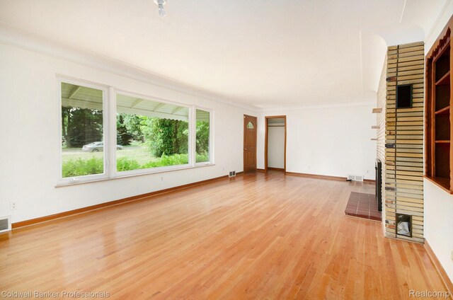2740 Judah Rd, Lake Orion, MI 48359 - unfurnished living room featuring a fireplace, light wood finished floors, and ornamental molding