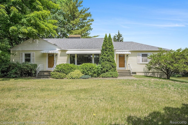 2740 Judah Rd, Lake Orion, MI 48359 - view of front of home with entry steps, a chimney, a front yard, and a shingled roof