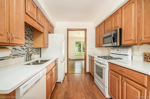 2740 Judah Rd, Lake Orion, MI 48359 - kitchen with white appliances, wood finished floors, light countertops, tasteful backsplash, and brown cabinets