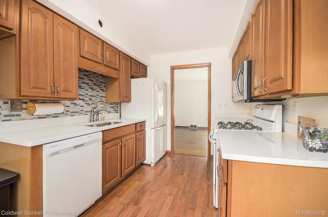 2740 Judah Rd, Lake Orion, MI 48359 - kitchen with white appliances, light wood-style flooring, decorative backsplash, and light countertops