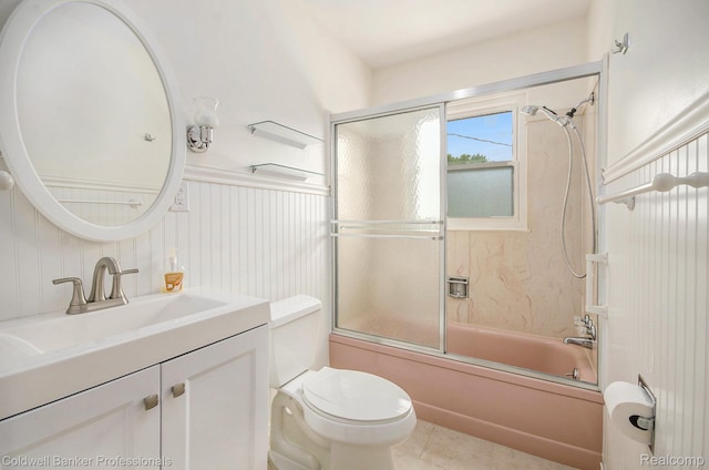 2740 Judah Rd, Lake Orion, MI 48359 - bathroom featuring vanity, shower / bath combination with glass door, tile patterned floors, and a wainscoted wall