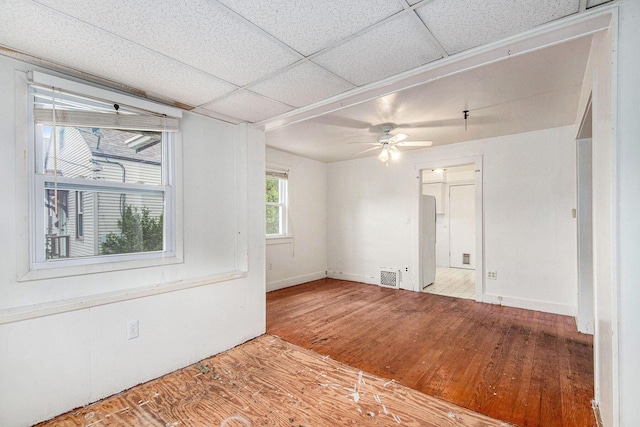 1137 Merrifield St SE, Grand Rapids, MI 49507 - spare room featuring hardwood / wood-style flooring, a ceiling fan, and a drop ceiling
