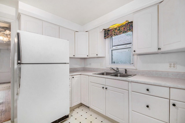 1137 Merrifield St SE, Grand Rapids, MI 49507 - kitchen with freestanding refrigerator, light floors, white cabinetry, and light countertops