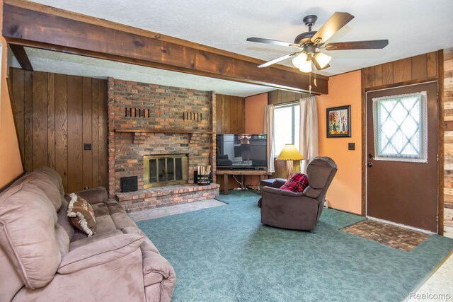 202 Redwine Dr, Houghton Lake, MI 48629 - carpeted living area with wooden walls, ceiling fan, and a fireplace