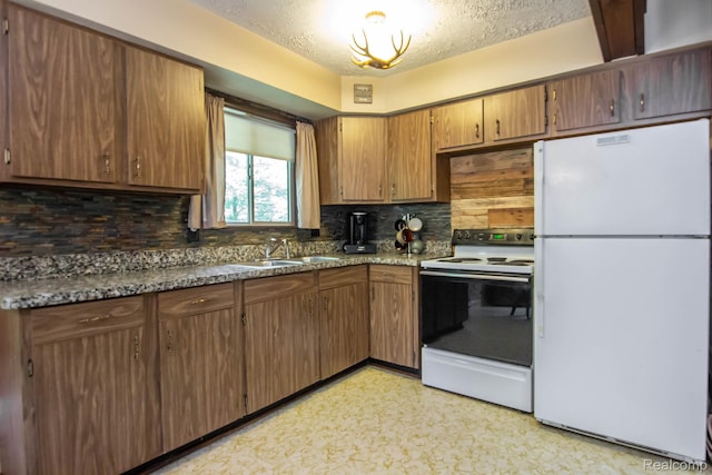 202 Redwine Dr, Houghton Lake, MI 48629 - kitchen with white appliances, decorative backsplash, a textured ceiling, light floors, and brown cabinets